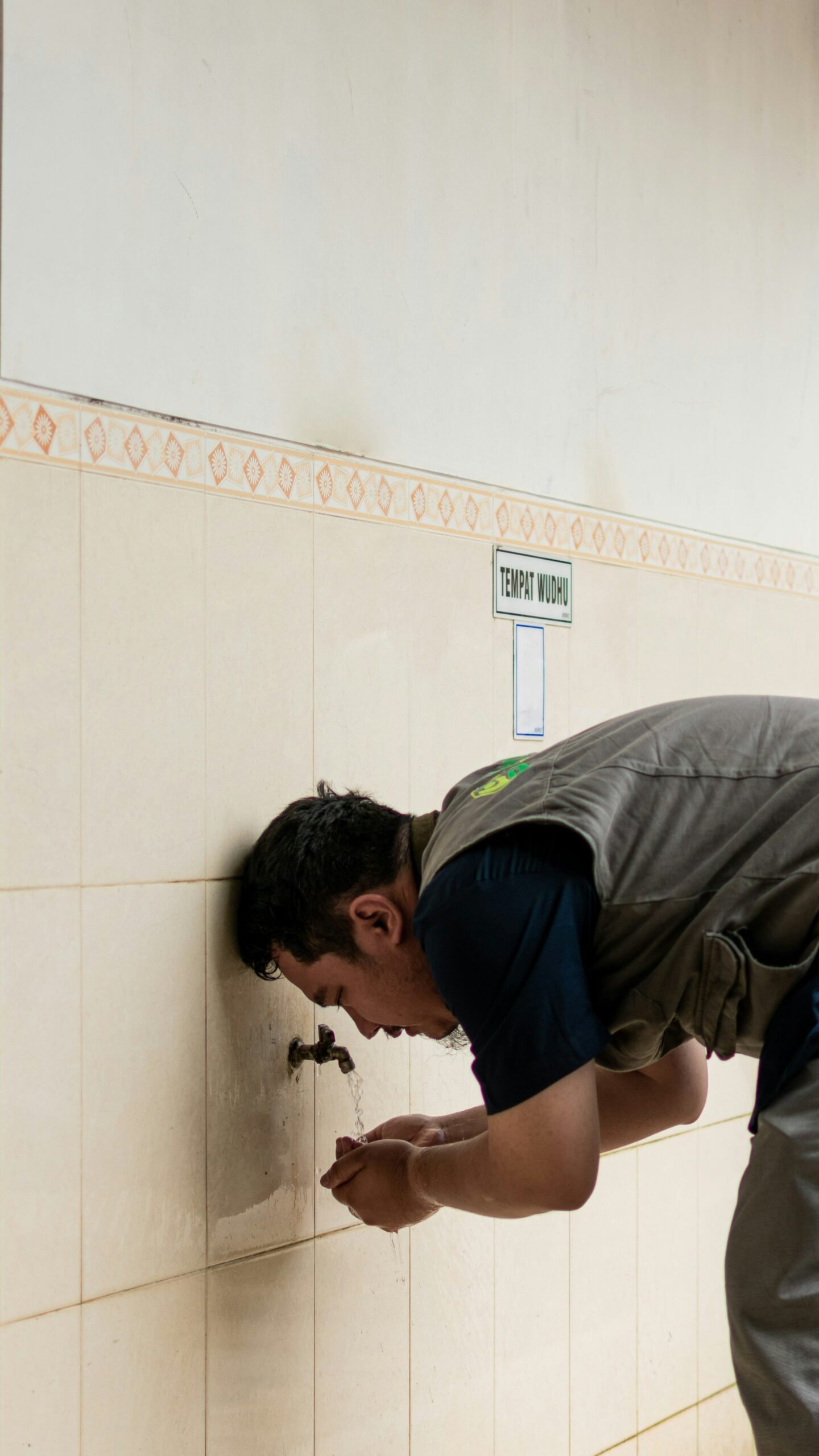 a man leaning against a wall with his hand on the wall